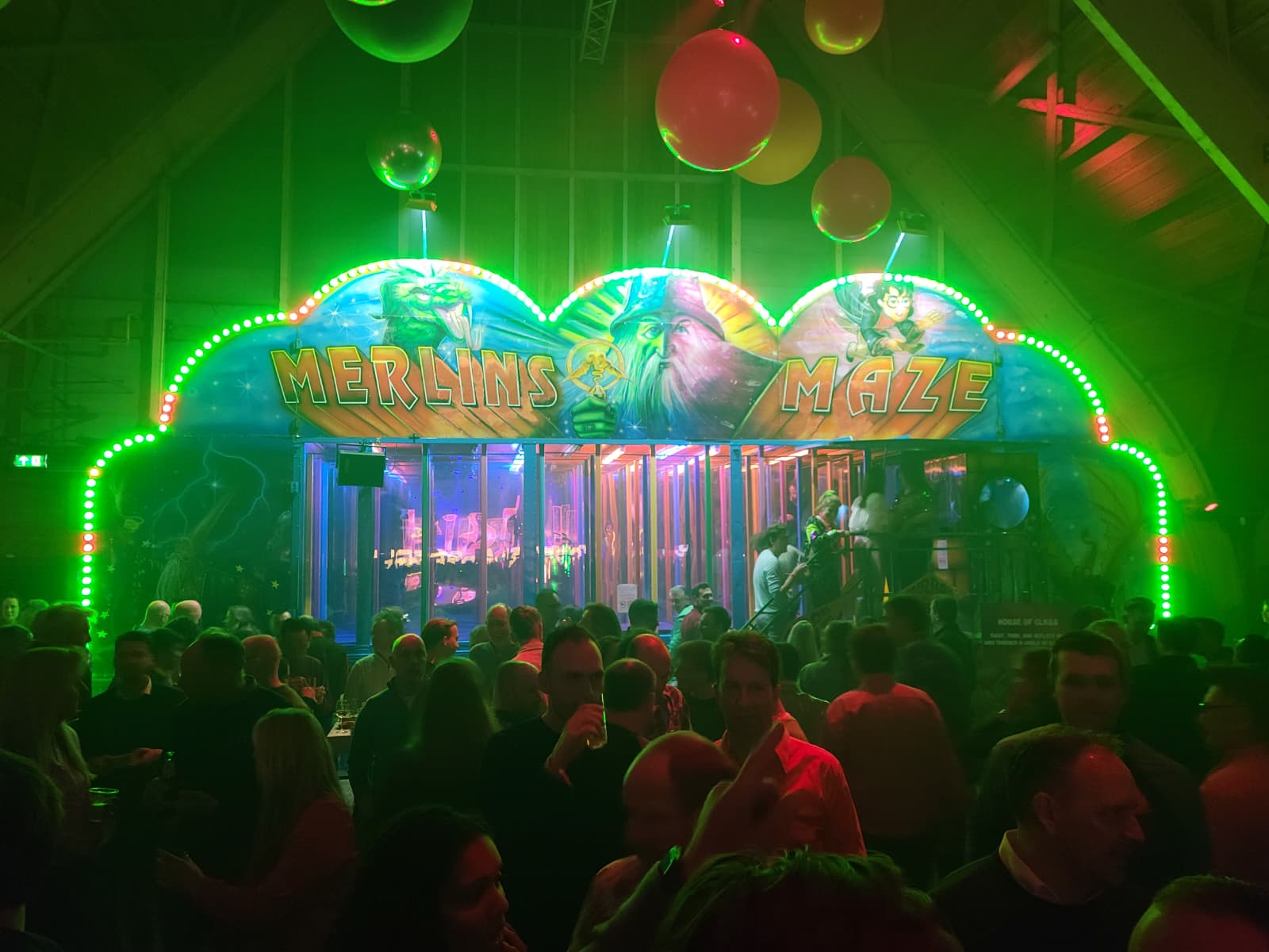 Ingang van spiegeldoolhof Merlin's Maze met neonverlichting, tijdens een bedrijfsevenement in de avond